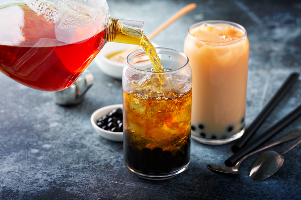 Pouring tea over lychee jelly and pearls